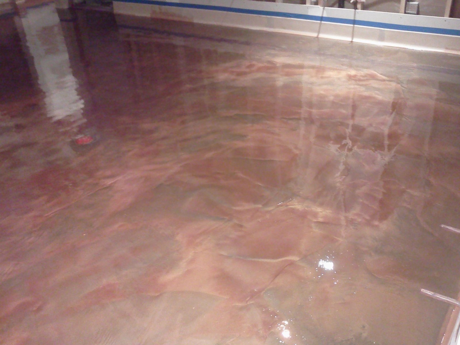 Glossy decorative interior concrete floor with bronze metallic finish