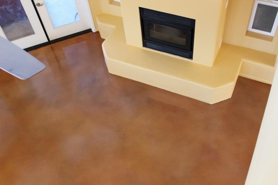 Brown polished interior concrete floor around fireplace